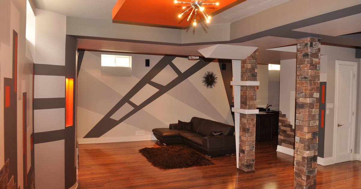 The finished basement of a mid-century modern home with exposed brick and a mid-century modern chandelier.