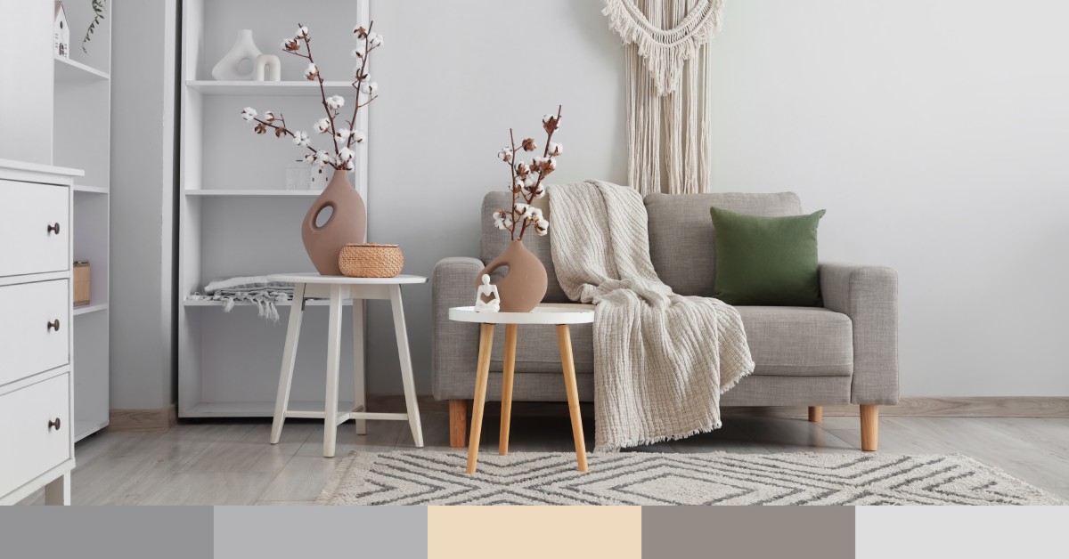 The interior of a modern home with a grey loveseat, white wooden endtables, and white shelving with color swatches.