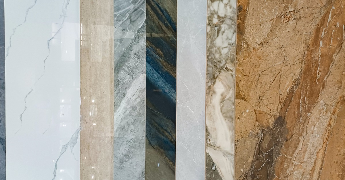 A close-up of a collection of vertical stone textures, including marble and granite, in various colors.