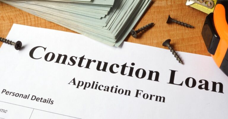 A close-up of a white sheet of paper with "Construction Loan" at the top, next to $100 bills, and screws.