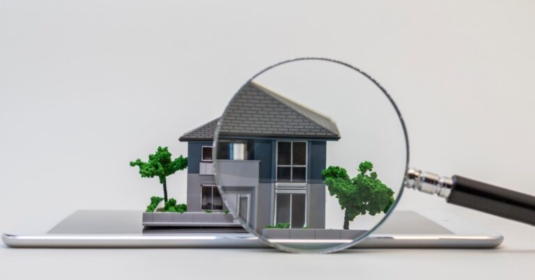 A point-of-view of looking through a magnifying glass at a miniature house model with a focus on the roof.