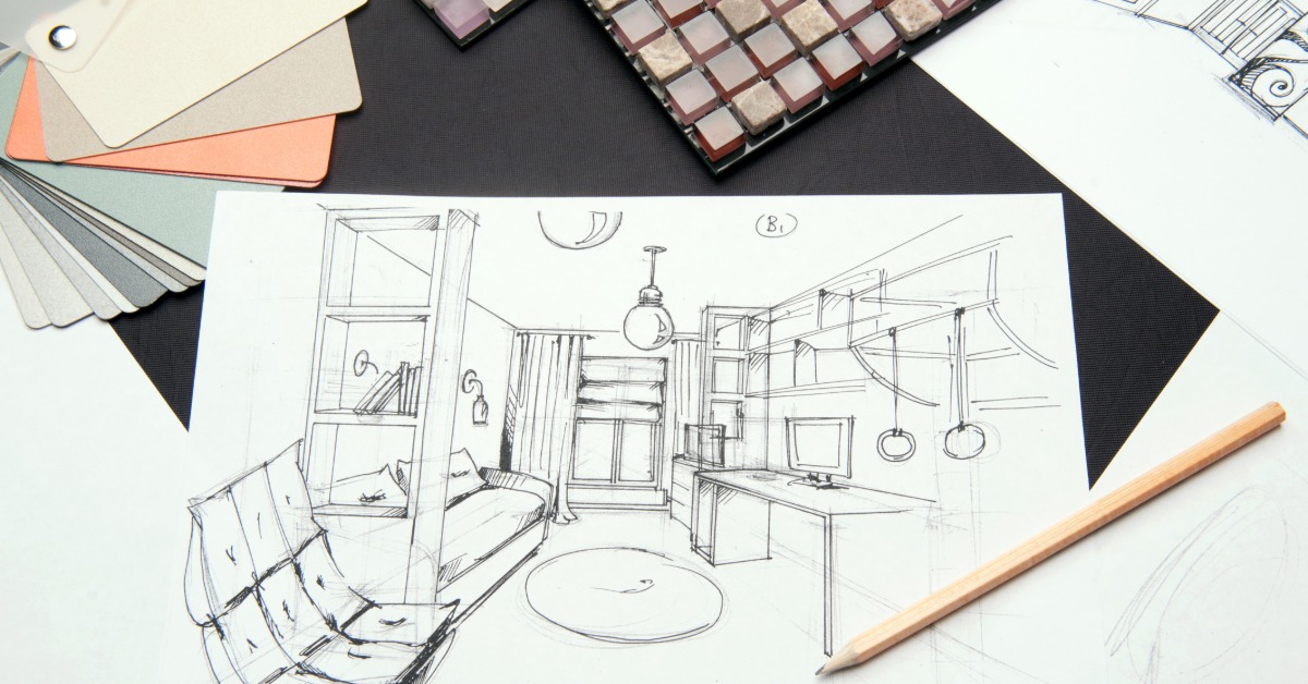 A close-up of an interior design room sketch of an office on a desk next to color samples and a pencil.