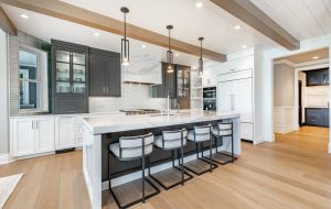 Luxurious high end kitchen with stainless appliances marble and glass tile