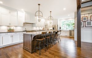 Home,Kitchen,Interior,With,Island,And,Bar,Stools,Hardwood,Floors