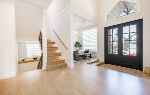 interior front room foyer entry with dining room fireplace staircase and wrought iron hand rails